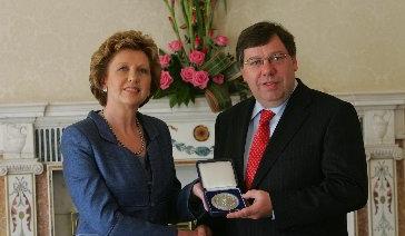 President Mary McAleese presents An Taoiseach Brian Cowen with his new seal of office.